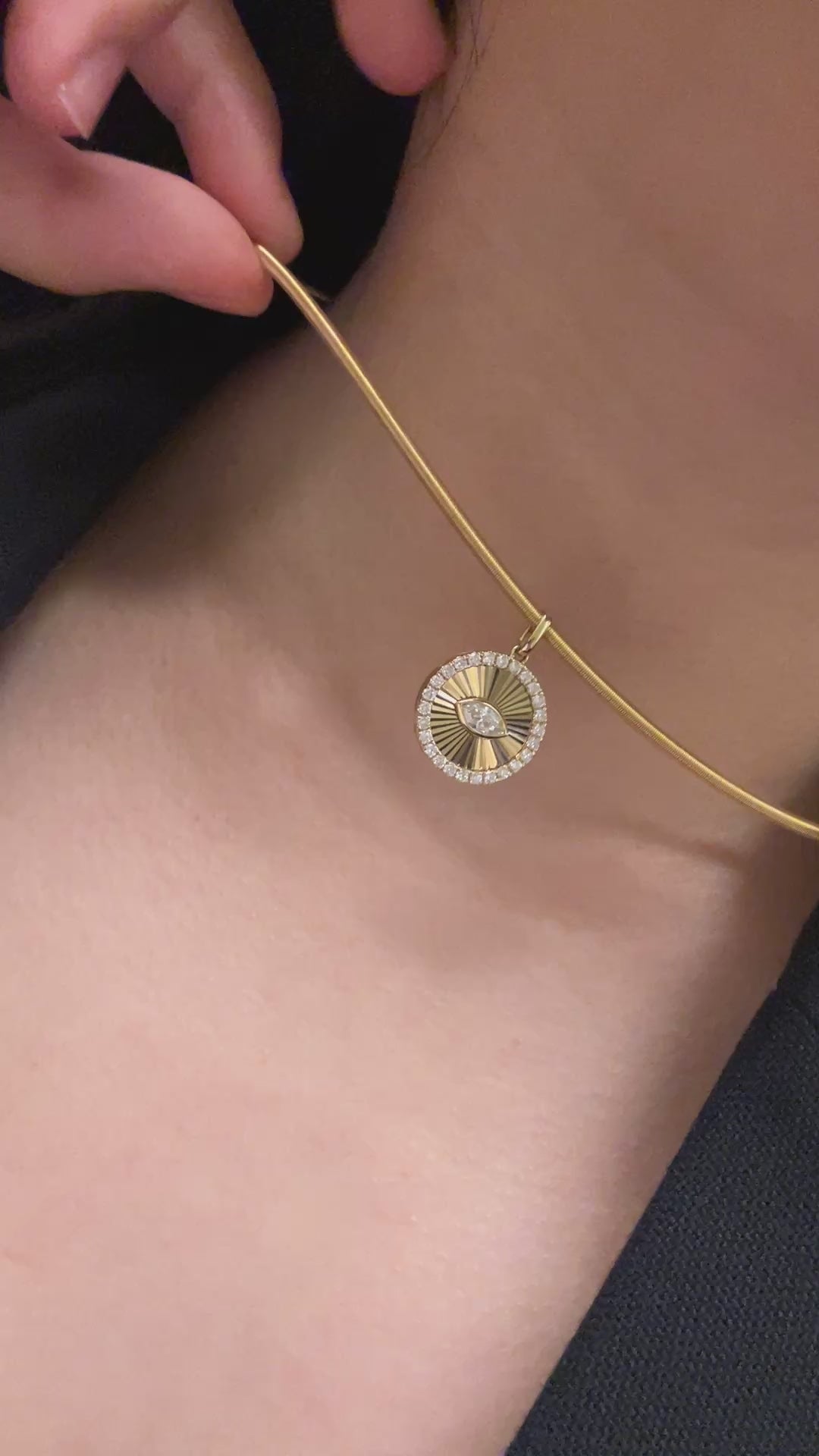 Guesthouse Meridian choker necklace in real life styled on a lady's neck with a pendant cut in Guilloche style.