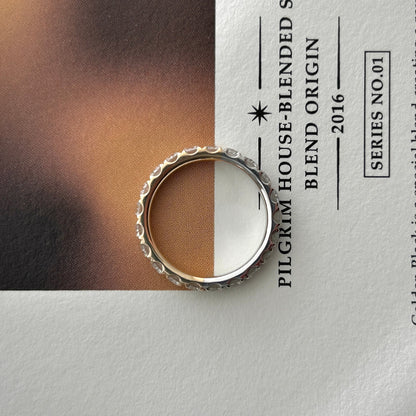 Two tone eternity ring in solid 14K yellow and white gold with lab-grown diamonds in a lifestyle setting.